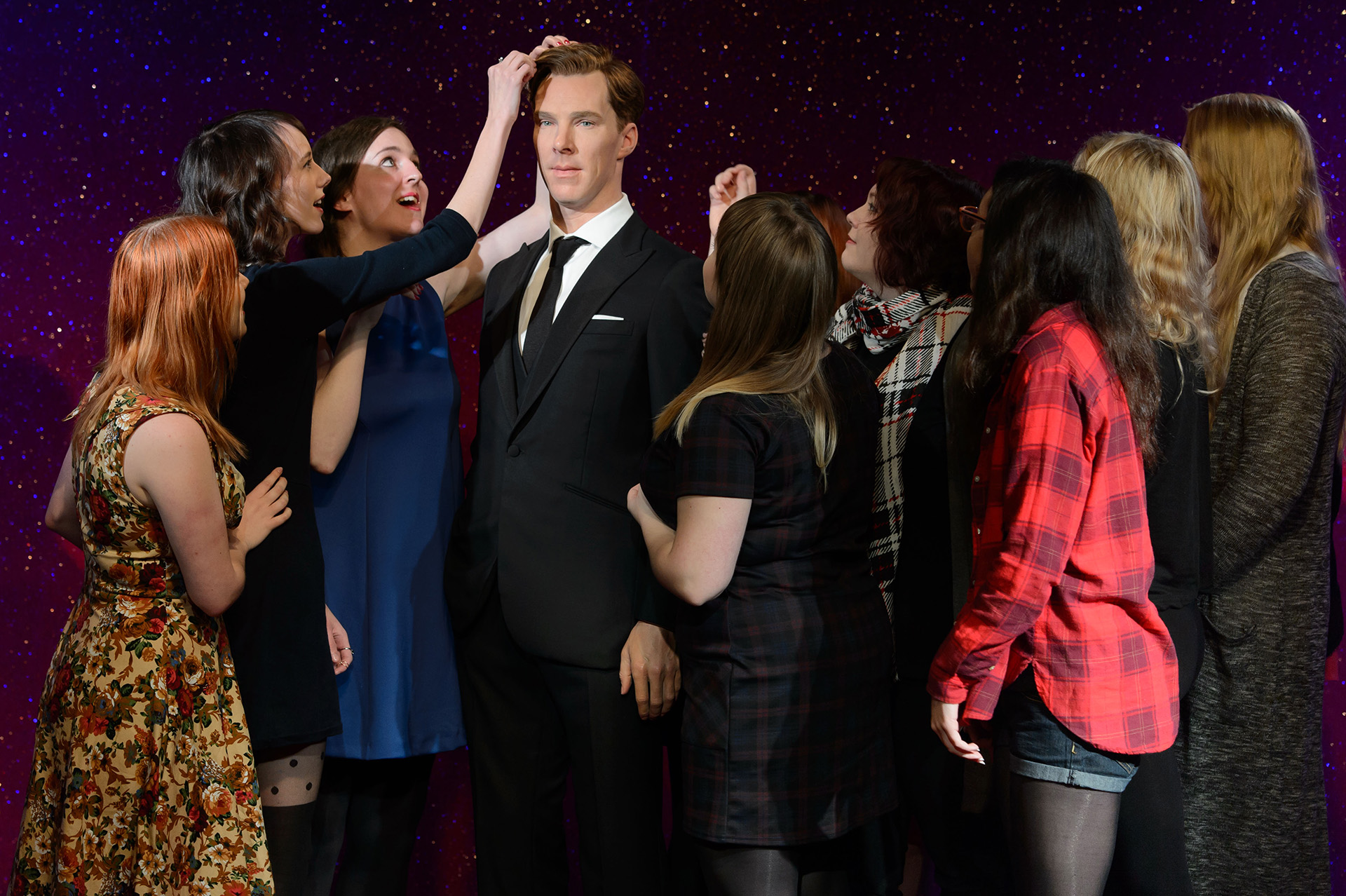 Fans interacting with Benedict Cumberbatch figure at Madame Tussauds London